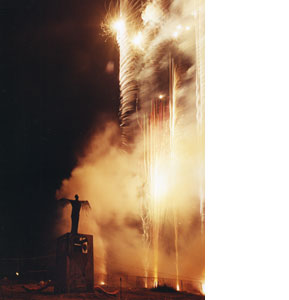 Photgraph of the Messenger of Fire by a fire works display at Glastonbury Festival